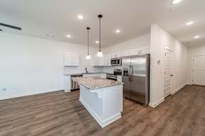 Kitchen with hanging lights at The Grove in Rogers, AR