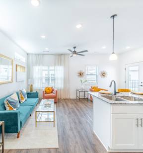 Living room with custom LVT flooring at The Grove in Rogers, AR