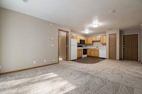 A kitchen area with a refrigerator, microwave, and oven.