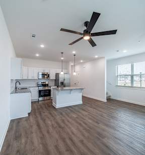 Spacious living room with premium hard wood flooring at The Grove in Rogers, AR