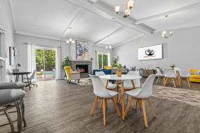 a living room with a table and chairs and a fireplace at Apple Ridge Apartments - Livonia, MI, Livonia, MI