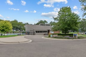 a building with a gray roof and a roundabout in front of it