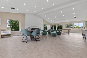 the gathering room with chairs and tables and a fireplace at Edge At Farmington Hills - Farmington Hills, MI, Farmington Hills, MI