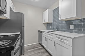 a kitchen with white cabinets and a stove and refrigerator