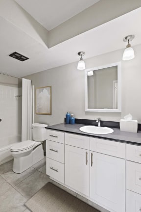 a white bathroom with a sink and a toilet