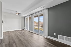 an empty living room with sliding glass doors to a balcony