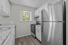 a kitchen with stainless steel appliances and white cabinets