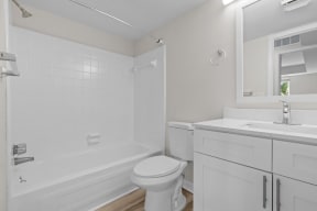 a white bathroom with a toilet and a sink