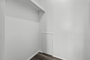 an empty room with white walls and a white door