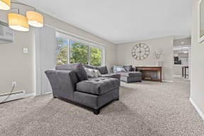 a living room with two couches and a fireplace at Apple Ridge Apartments - Livonia, MI, Livonia, 48152