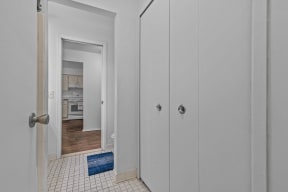 a bedroom with white closets and a door to a kitchen at Edge At Farmington Hills - Farmington Hills, MI, Farmington Hills, Michigan