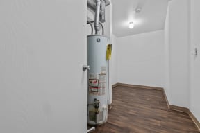 a white room with a gas heater in the corner at Edge At Farmington Hills - Farmington Hills, MI, Farmington Hills, MI