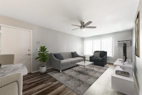 a living room with couches and a coffee table at Town & Country Apartments - Wixom, MI, Wixom