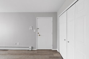 an empty room with white walls and a white door