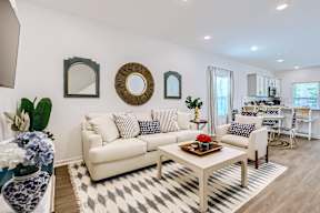 A living room with a white sofa and a coffee table.