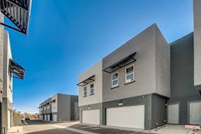 A modern building with a clear blue sky above it.