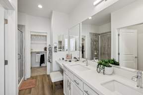 A bathroom with a white counter and a white sink.