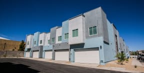 the exterior of a building with white and blue doors