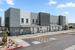 A building with a parking lot in front of it.