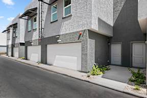 A modern building with grey walls and white garage doors.