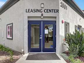 A leasing center with a blue door