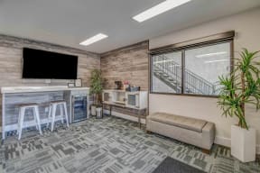 Leasing office waiting area with bench, coffee area and work station
