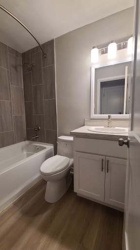 a small bathroom with a toilet sink and bath tub