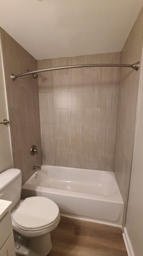 a bathroom with a toilet and a bath tub and a shower curtain