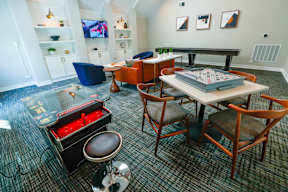 A room with a pool table and a television.