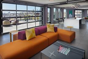 A modern living room with a large window overlooking the city.