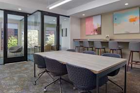 A conference room with a long table and chairs.