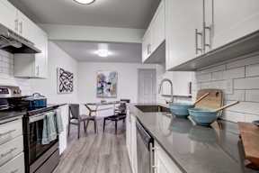 a kitchen and dining room with a table and chairs
