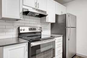 a kitchen with a stove and a refrigerator