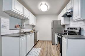 a kitchen with a stove top oven next to a refrigerator
