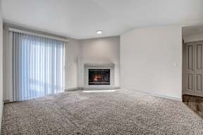 a living room with a fireplace and a window