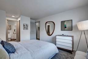 a bedroom with a bed and a dresser in it