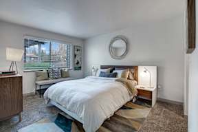 a bedroom with a large bed and a large window