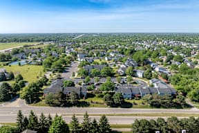 A bird's eye view of a residential neighborhood with houses and trees.