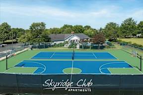 A basketball court with the words Skyridge Club Apartments written on it.