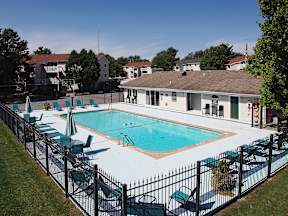 A black fence surrounds a small pool.