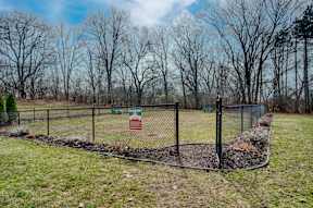A fenced area with a sign on it.