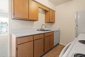 A kitchen with wooden cabinets and a white countertop.