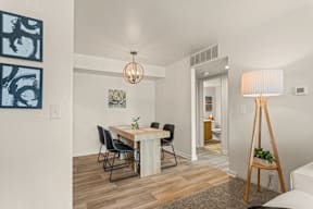 A dining room with a table and chairs.