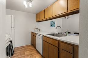 A kitchen with wooden cabinets and a white countertop.