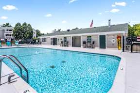 A large swimming pool with a building in the background.