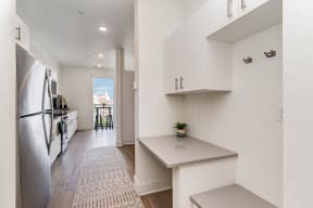 a renovated kitchen with white cabinets and stainless steel appliances  at City View Apartments, Michigan