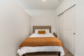 a bedroom with a bed and a closet  at City View Apartments, Michigan