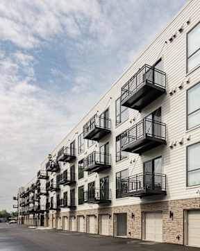 A long building with balconies on the second floor.
