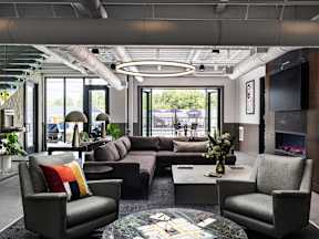 A modern living room with a grey sofa set and a coffee table.