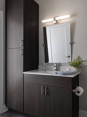 A bathroom with a sink and a mirror.